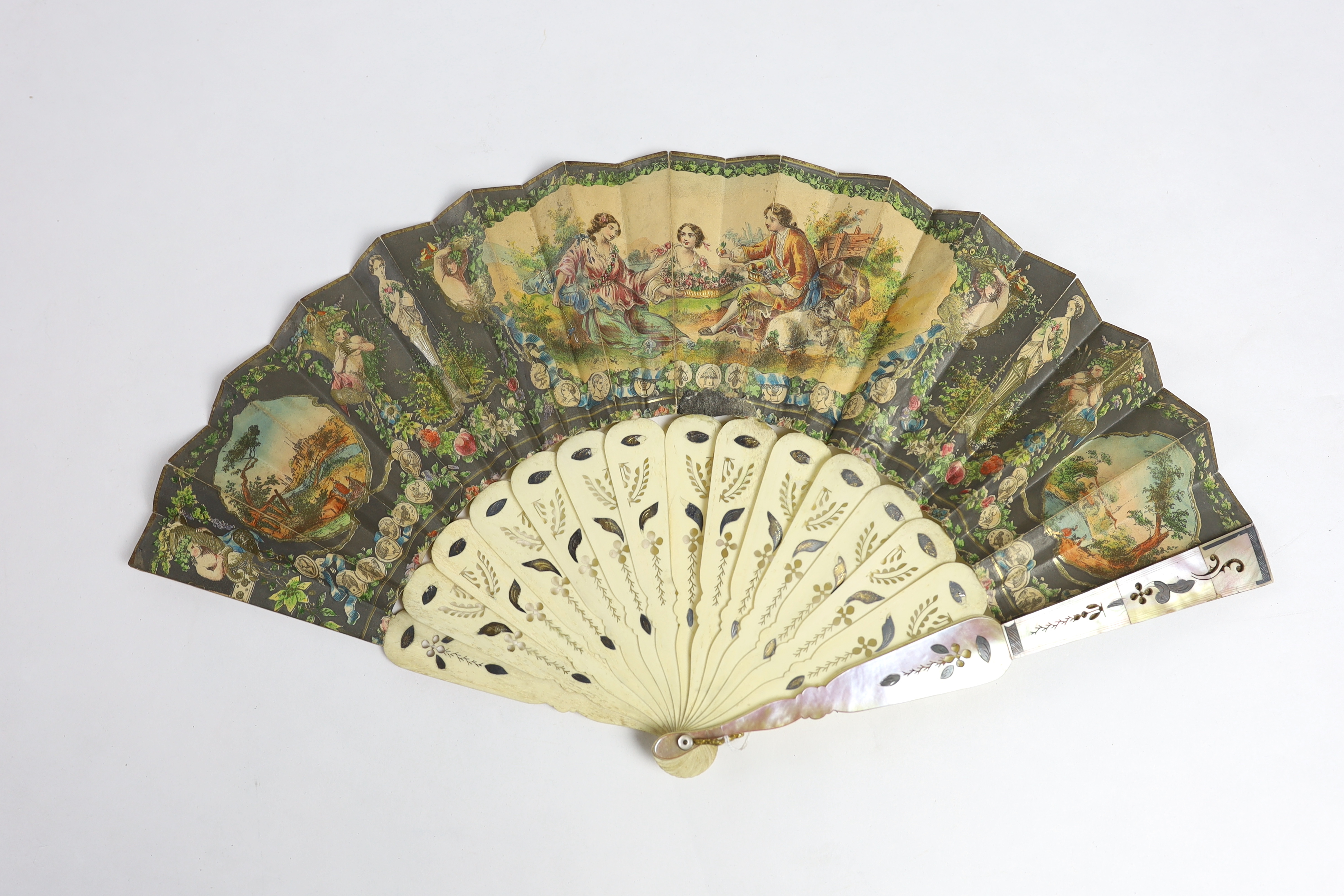 A 19th century mother of pearl and carved bone fan with ornate printed paper leaf, together with a similar Spanish fan of dancers, with mother of pearl guards, signed.
